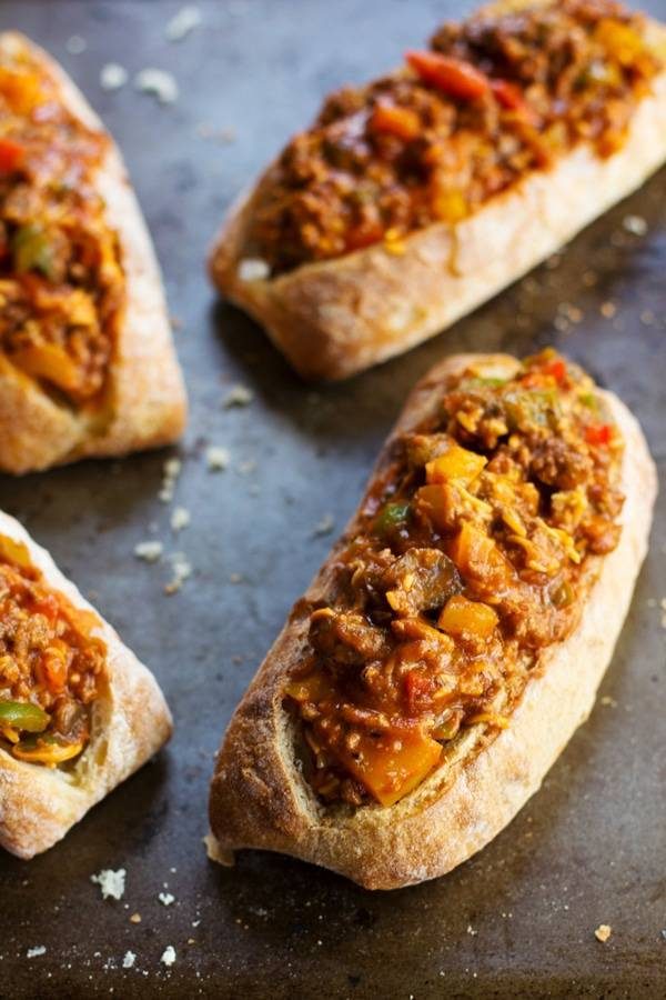 Four pieces of pizza bread on a pan.